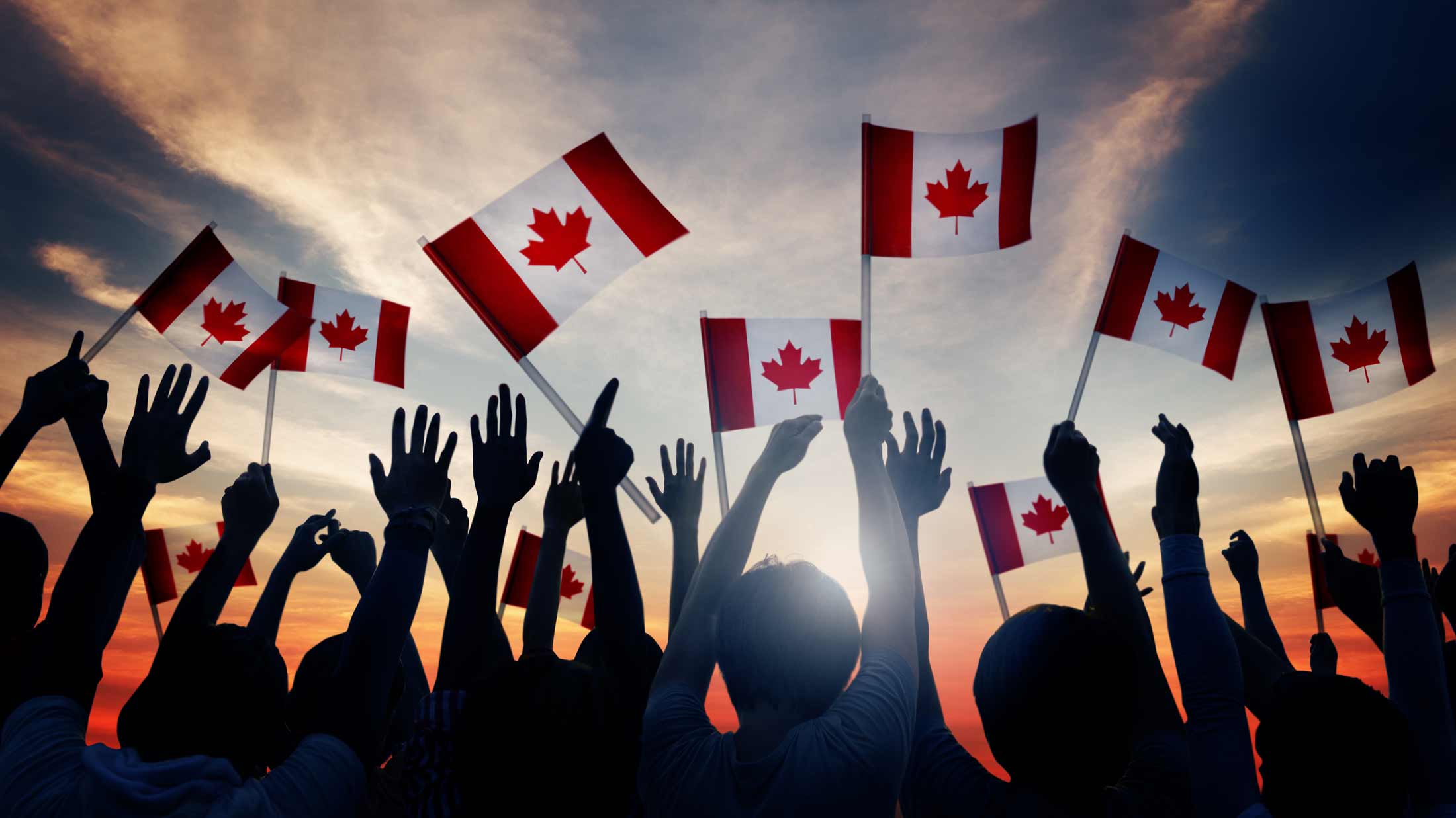 people waving canada flags